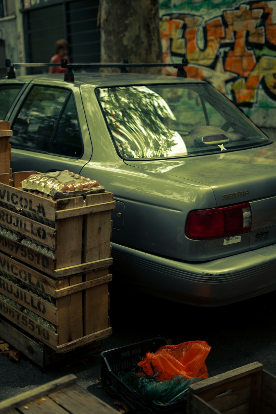 Portrait of an elderly Uruguayan car collector standing beside a classic automobile
