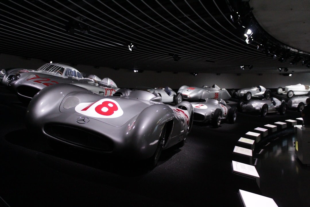 Digital automotive gallery interior with cars displayed under museum lighting