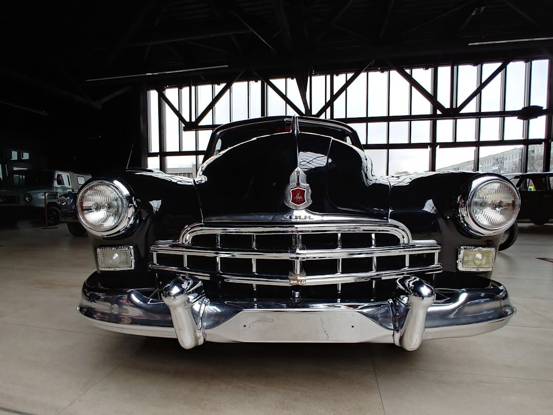 Restored 1950s luxury sedan photographed in a studio setting