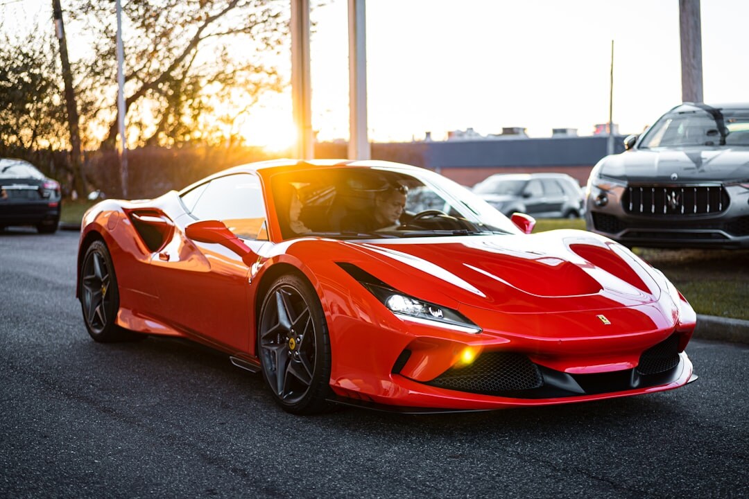 Red vintage Ferrari parked on a historic Montevideo street at dusk