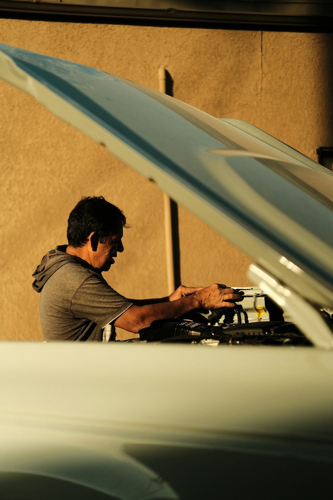 car enthusiast examining engine